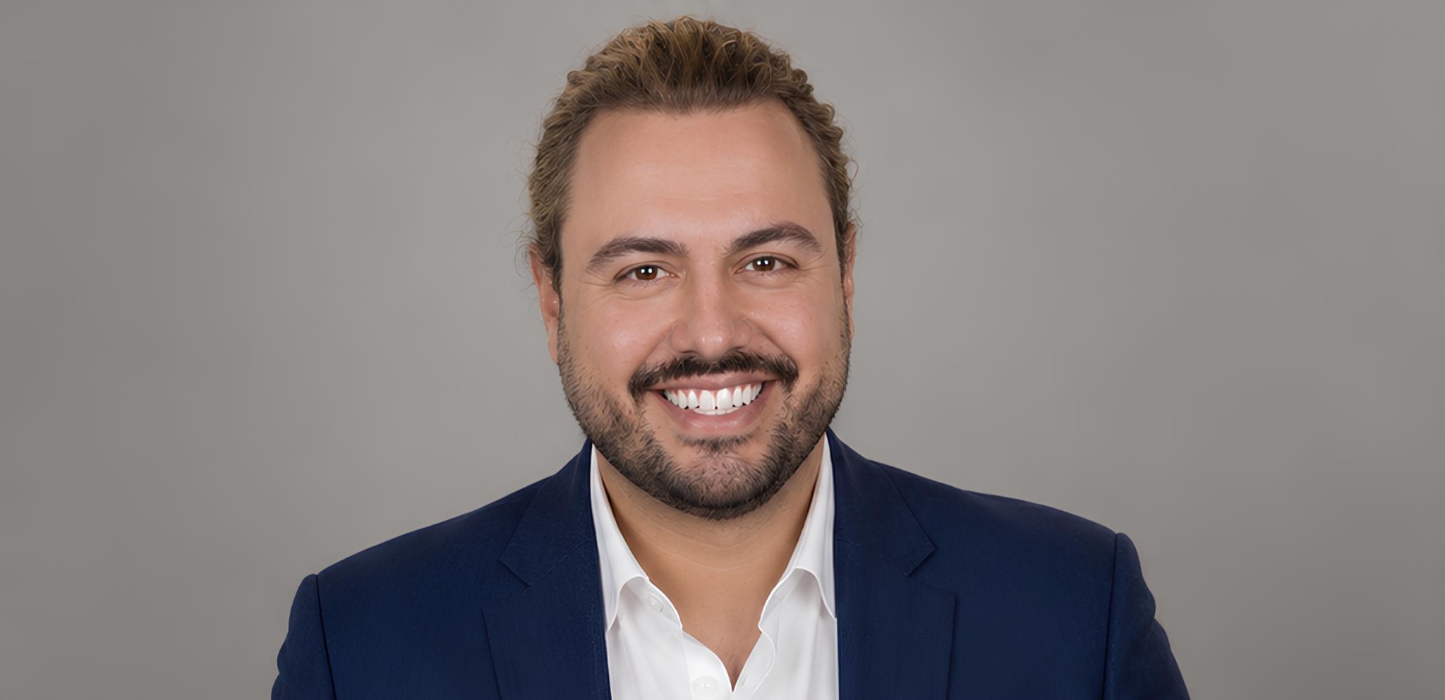 Professional studio portrait of Dr. Theofanis (Fanis) Aritzis