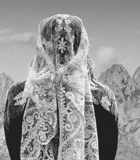 Veiled lament singer against the mountains of Epirus